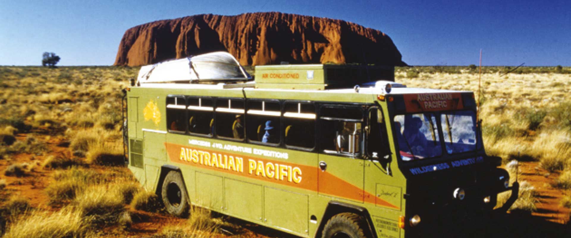 historical image 1980s bus in front of uluru australia